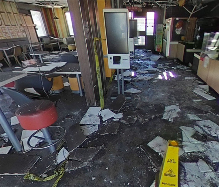 Ceiling tiles and other debris cover the floor of a fire